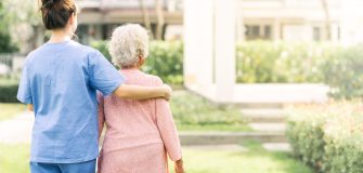 Image of a luxury old age home showing a female nurse with a female retiree