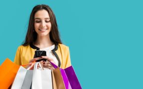 woman holding shopping bags while shopping using high end luxury shopping apps